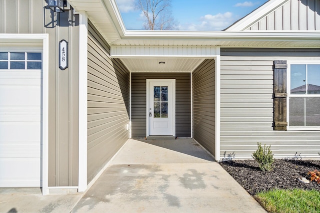 property entrance featuring board and batten siding and an attached garage