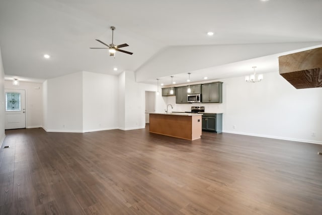 unfurnished living room featuring baseboards, dark wood-style flooring, ceiling fan with notable chandelier, a sink, and recessed lighting