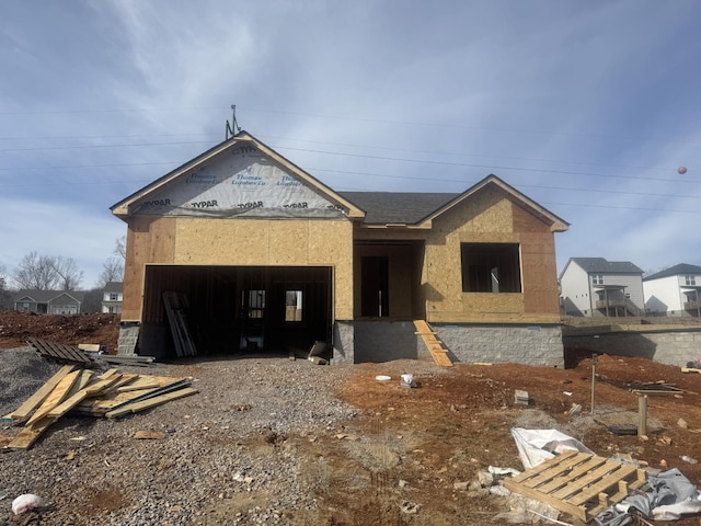 unfinished property with a garage, driveway, and stucco siding