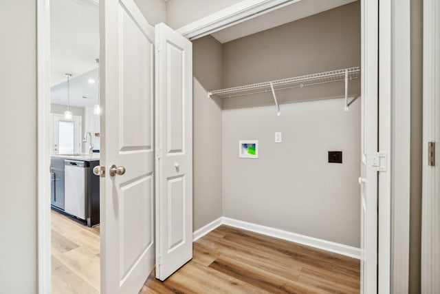 laundry room with sink, washer hookup, hookup for an electric dryer, and hardwood / wood-style floors