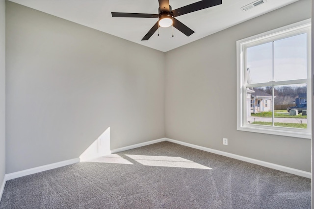 carpeted spare room featuring ceiling fan