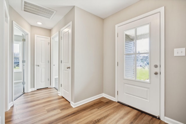 foyer featuring plenty of natural light and light hardwood / wood-style flooring