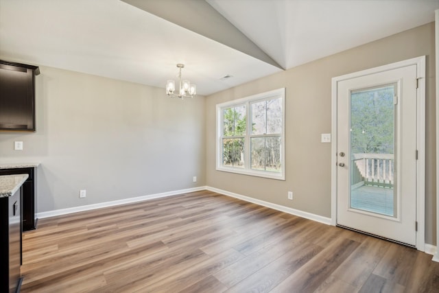 interior space featuring an inviting chandelier and light hardwood / wood-style floors