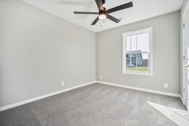 carpeted spare room with ceiling fan