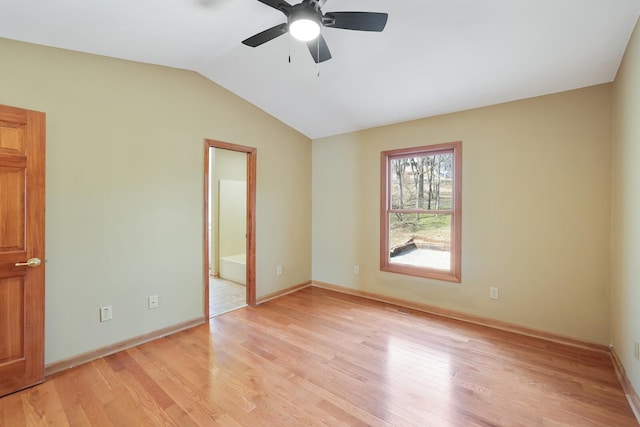 empty room featuring vaulted ceiling, ceiling fan, and light hardwood / wood-style flooring