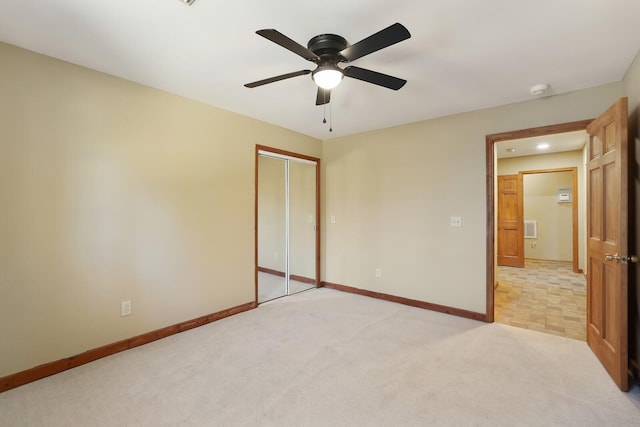 unfurnished bedroom with light carpet, a closet, and ceiling fan