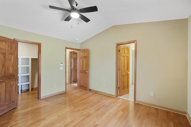 unfurnished bedroom featuring vaulted ceiling and light hardwood / wood-style flooring