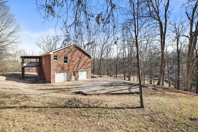 view of property exterior with a garage and a yard