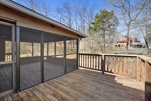 wooden deck featuring a sunroom