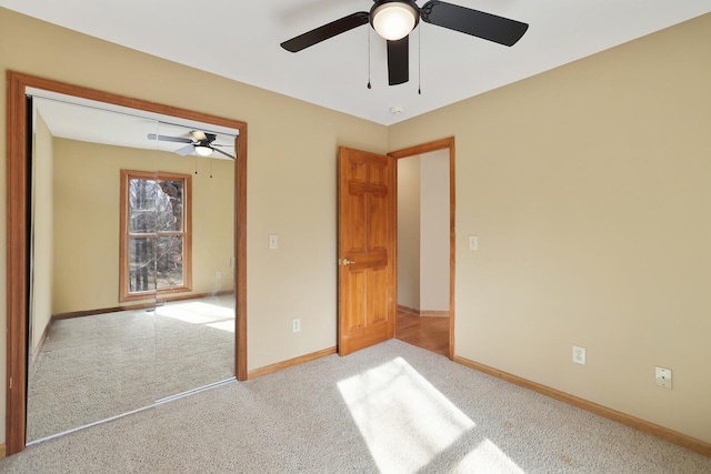 unfurnished bedroom with light colored carpet, ceiling fan, and a closet