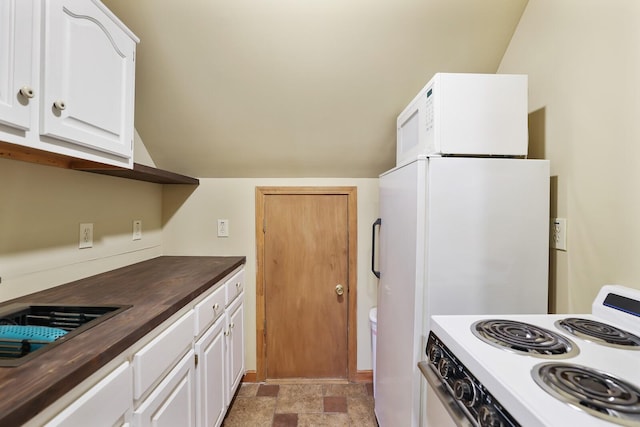 kitchen featuring sink, butcher block countertops, white cabinetry, vaulted ceiling, and white appliances