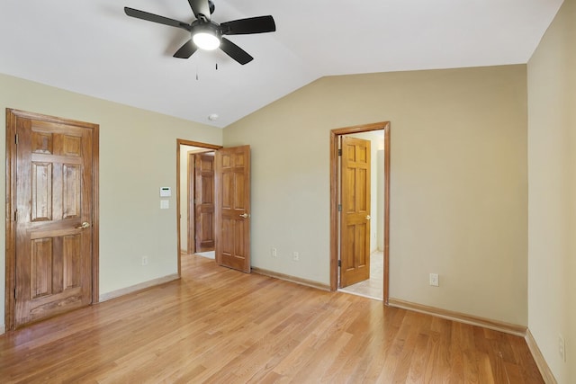 unfurnished bedroom featuring ceiling fan, connected bathroom, light hardwood / wood-style floors, and vaulted ceiling