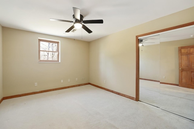 spare room featuring light carpet and ceiling fan