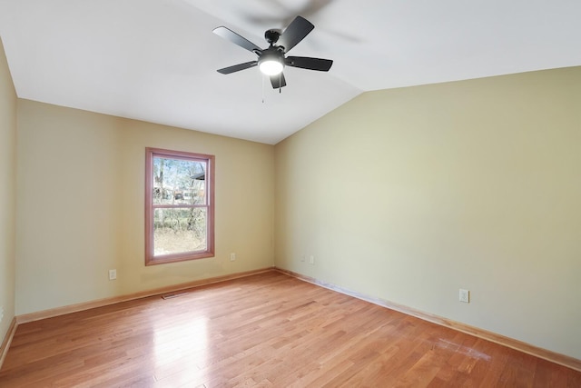 spare room with vaulted ceiling, ceiling fan, and light wood-type flooring