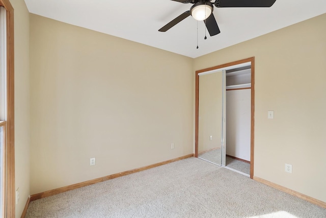 unfurnished bedroom with ceiling fan, a closet, and light carpet