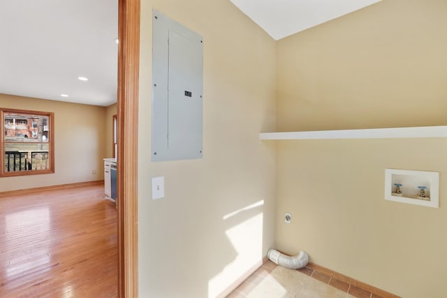 washroom with washer hookup, hookup for an electric dryer, electric panel, and light hardwood / wood-style flooring