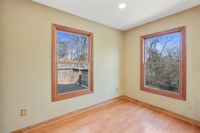 empty room with light hardwood / wood-style flooring