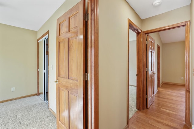 hallway with light colored carpet