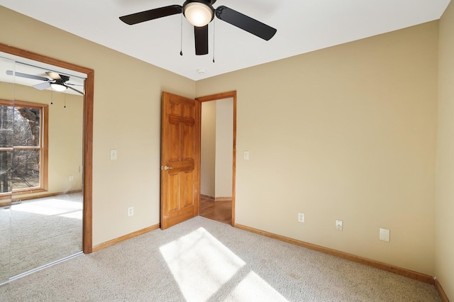 unfurnished bedroom with ceiling fan and light carpet