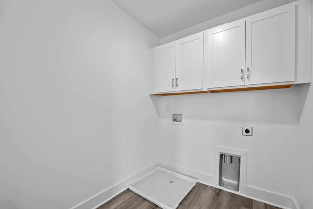 washroom with cabinets, washer hookup, dark hardwood / wood-style floors, and electric dryer hookup