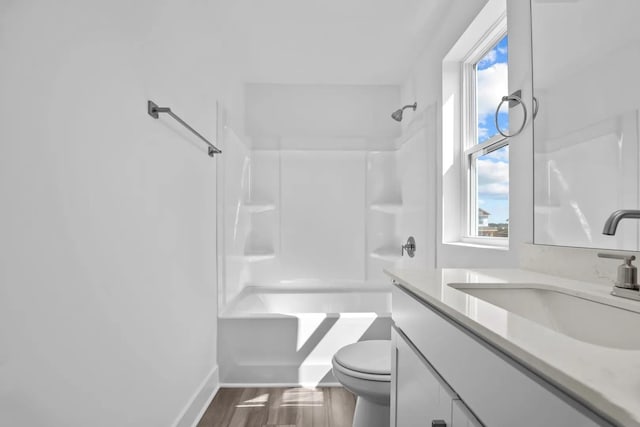 full bathroom with bathtub / shower combination, vanity, toilet, and wood-type flooring