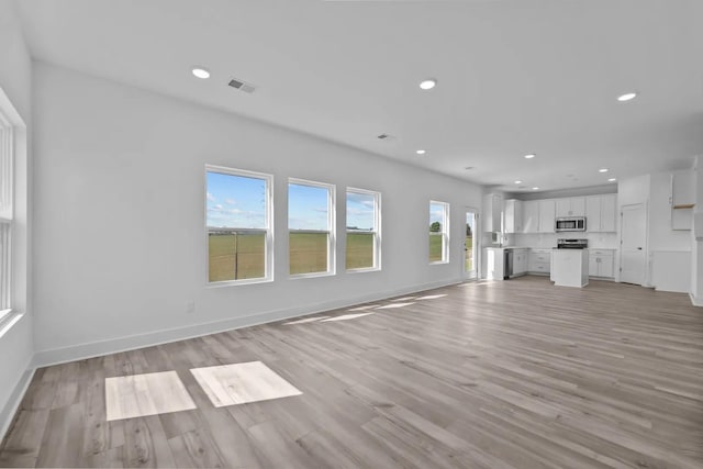 unfurnished living room with light wood-type flooring