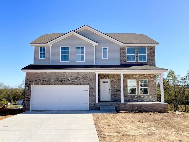 view of front of house with a porch and a garage