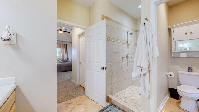 bathroom featuring a tile shower, vanity, and tile patterned floors