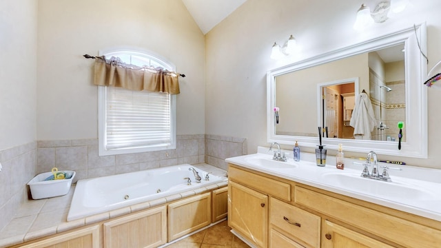 bathroom featuring vanity, tile patterned flooring, lofted ceiling, and a tub