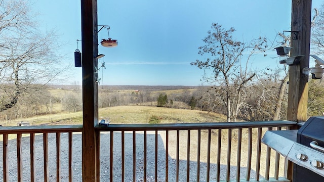 wooden terrace featuring a grill and a rural view