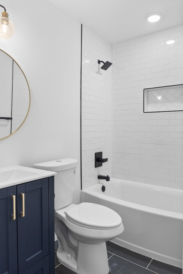 full bathroom featuring tile patterned floors, vanity, toilet, and tiled shower / bath