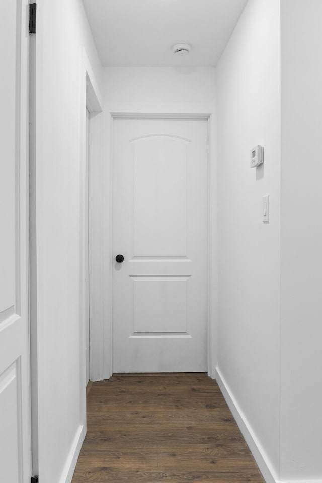 hall with dark wood-type flooring