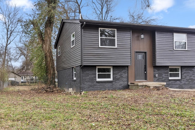 split foyer home with a front lawn