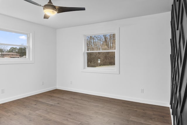 spare room featuring dark wood-type flooring and ceiling fan