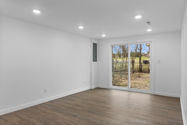 unfurnished room featuring dark wood-type flooring and electric panel