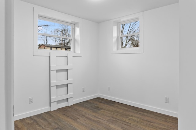 spare room featuring dark hardwood / wood-style flooring