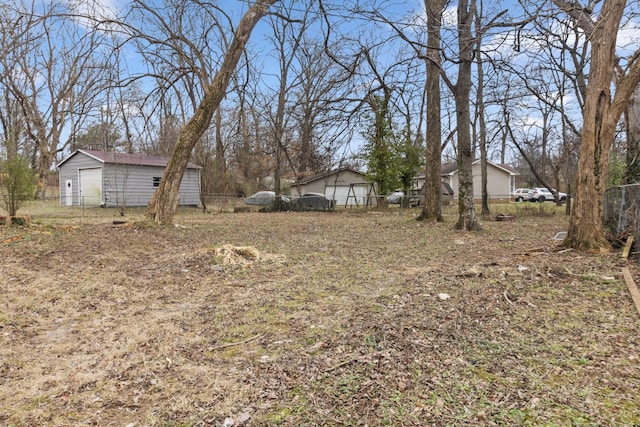 view of yard featuring an outbuilding and a garage