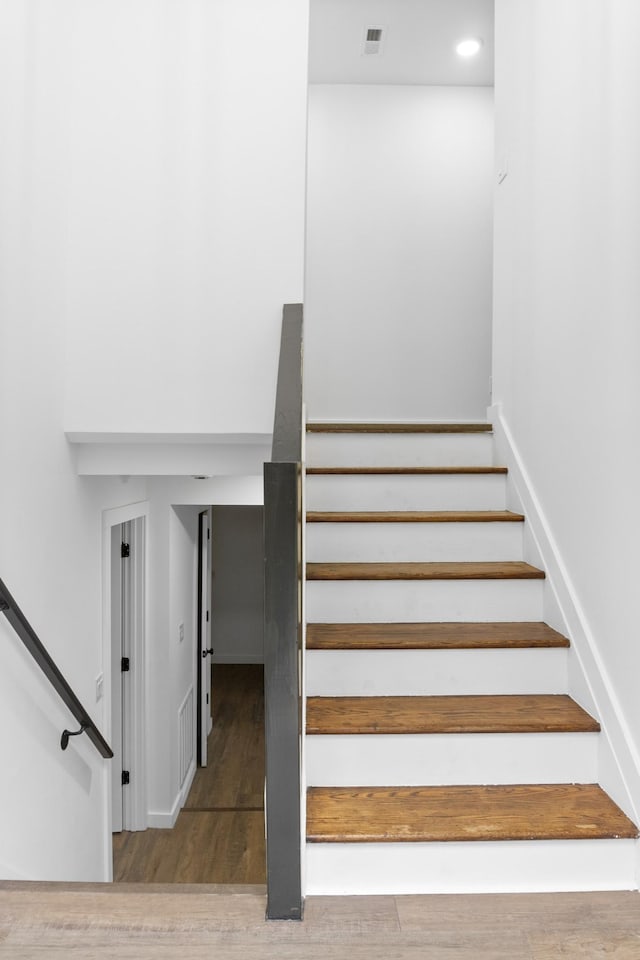 stairs with hardwood / wood-style floors