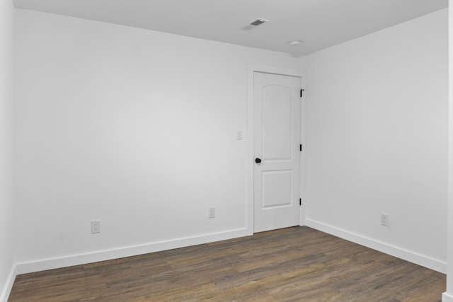 spare room featuring dark hardwood / wood-style flooring