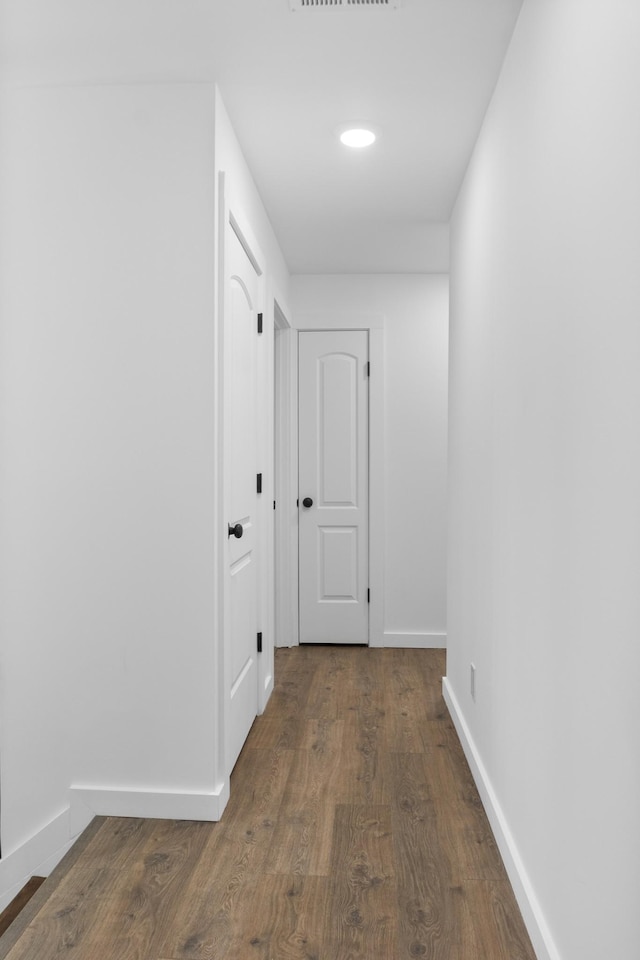 corridor featuring dark hardwood / wood-style floors