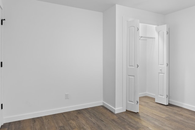 unfurnished bedroom featuring hardwood / wood-style floors and a closet