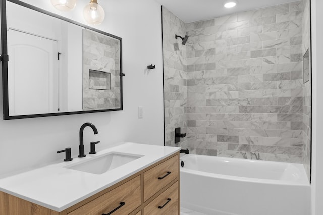 bathroom featuring vanity and tiled shower / bath combo