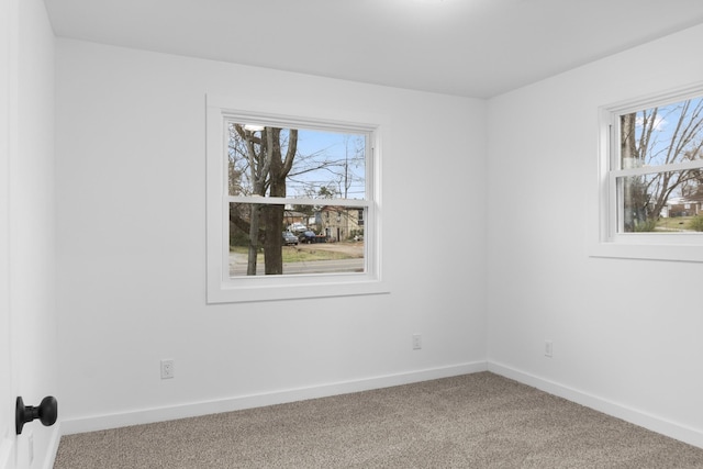 spare room with carpet and a healthy amount of sunlight