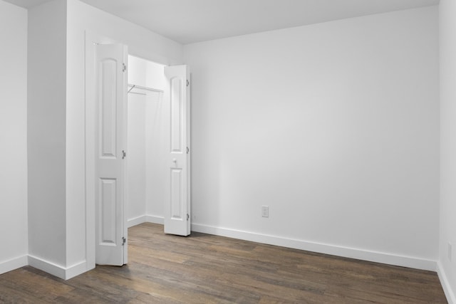 unfurnished room featuring dark wood-type flooring