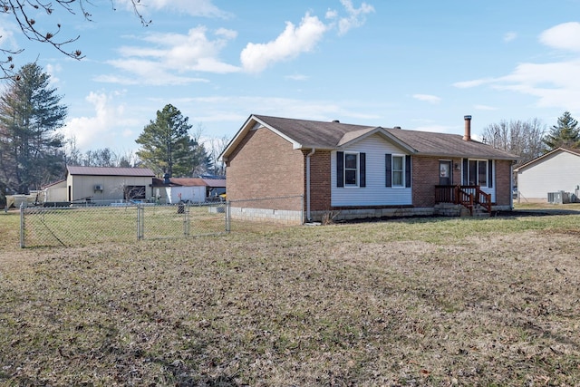 view of front of house with a front lawn and central air condition unit