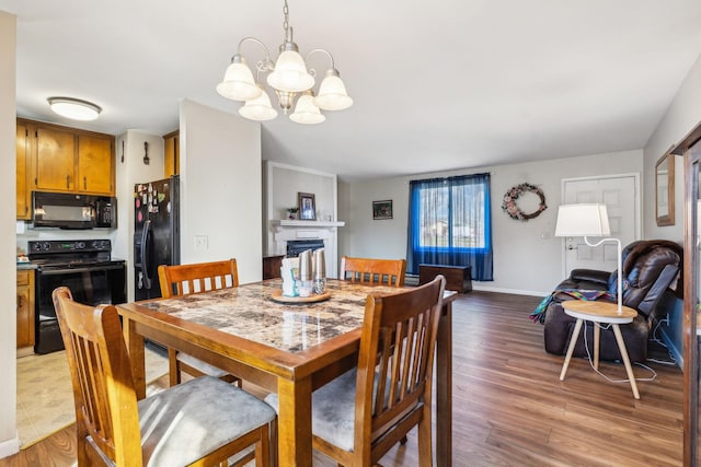 dining area featuring an inviting chandelier and light hardwood / wood-style floors