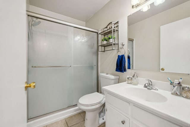 bathroom with walk in shower, vanity, toilet, and tile patterned flooring