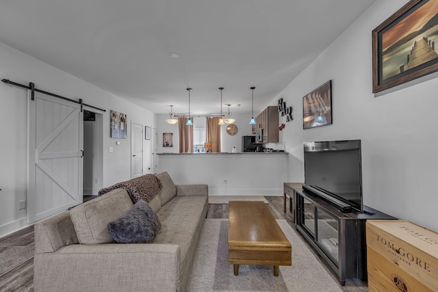 living room with light hardwood / wood-style floors and a barn door