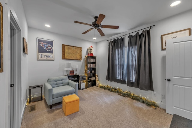 sitting room with carpet floors and ceiling fan