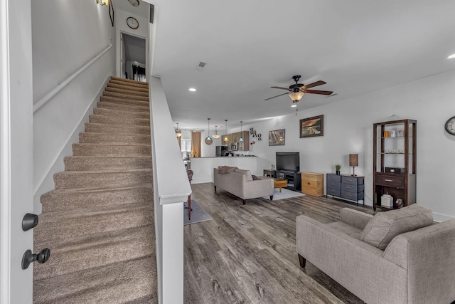 living room with hardwood / wood-style floors and ceiling fan